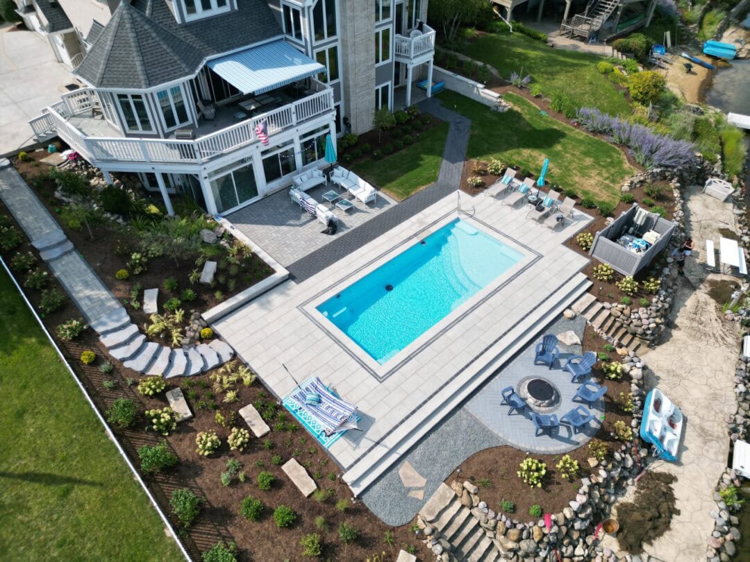 Modern backyard with pool and patio.