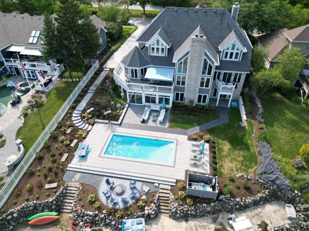 Elegant outdoor pool area with spacious deck and lounge chairs for relaxing.