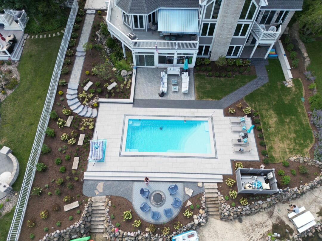 Aerial view of modern home with pool.