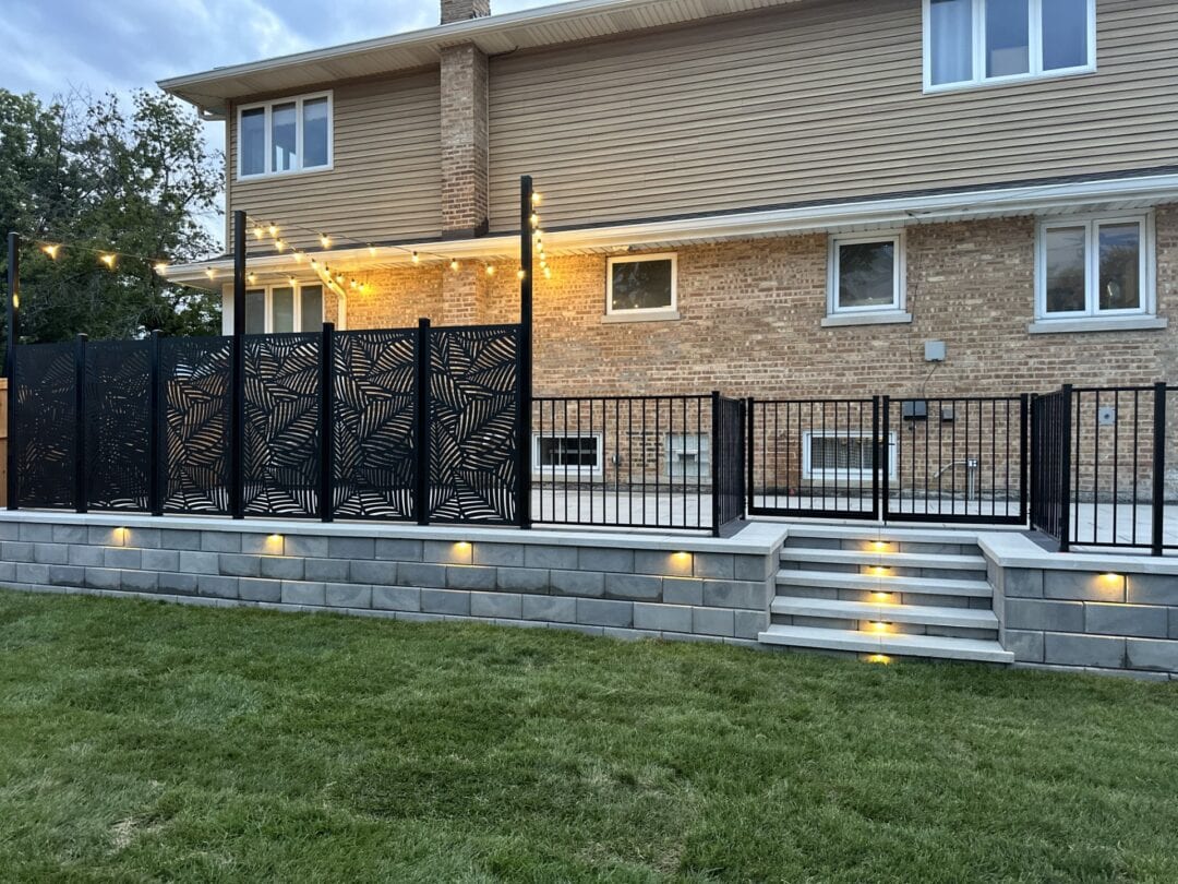 Brick house with decorative fence and lights