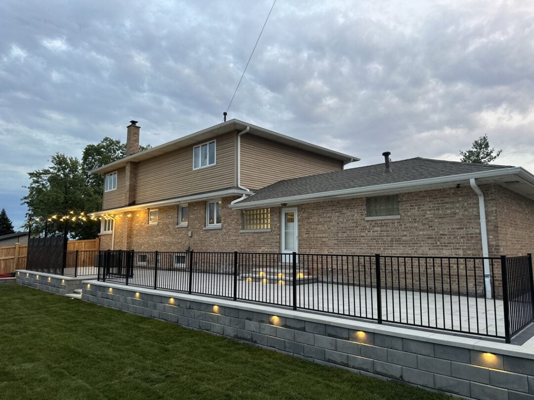 Brick house with backyard patio and lights