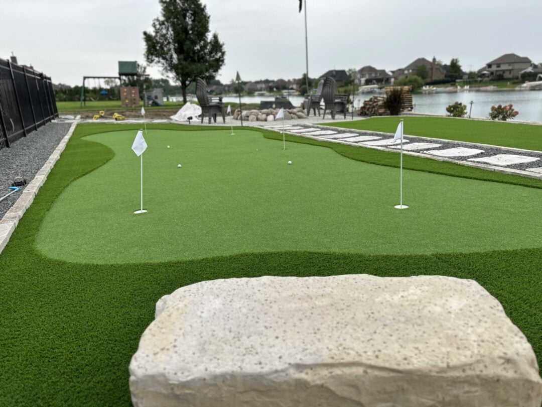 Outdoor putting green with water view, perfect for golf practice and outdoor recreation.