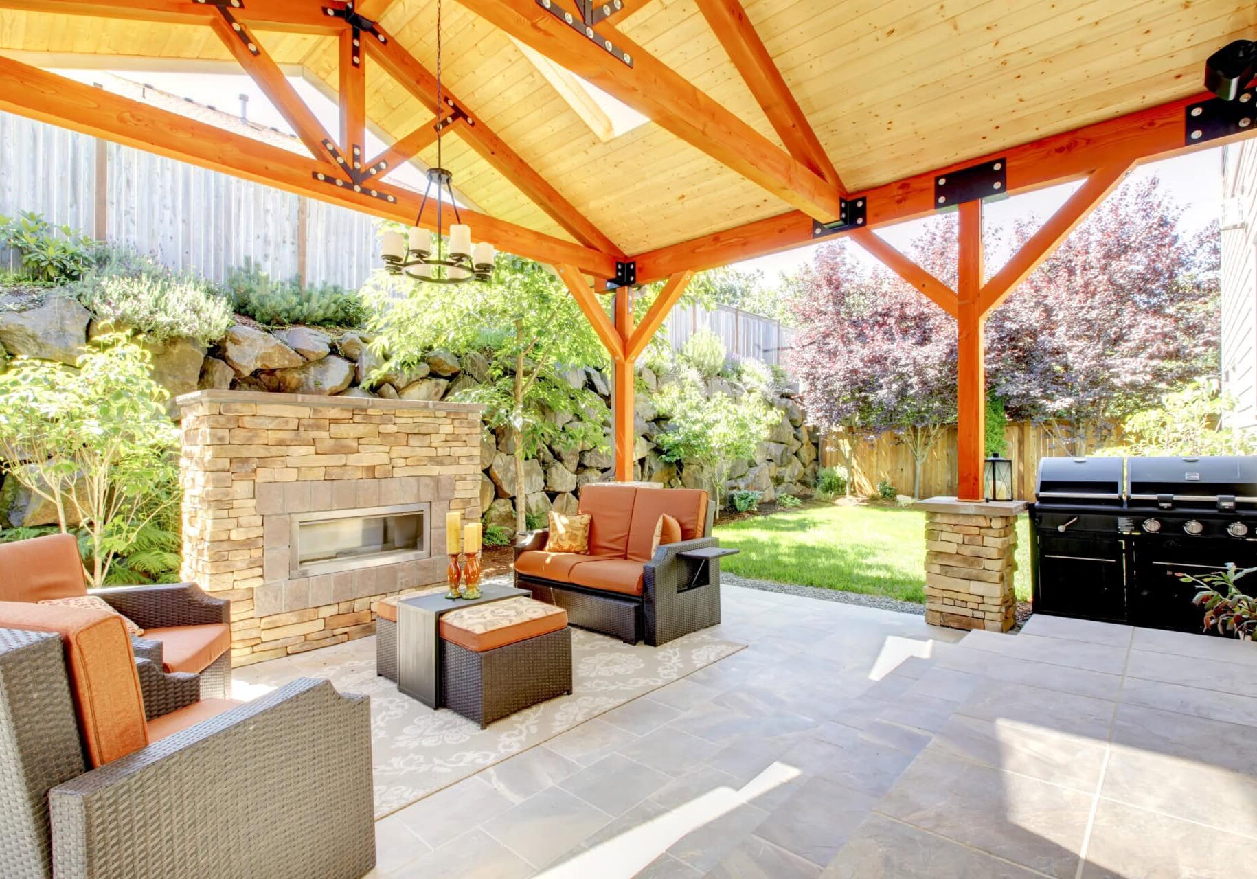 Covered patio with seating, fireplace, and grill