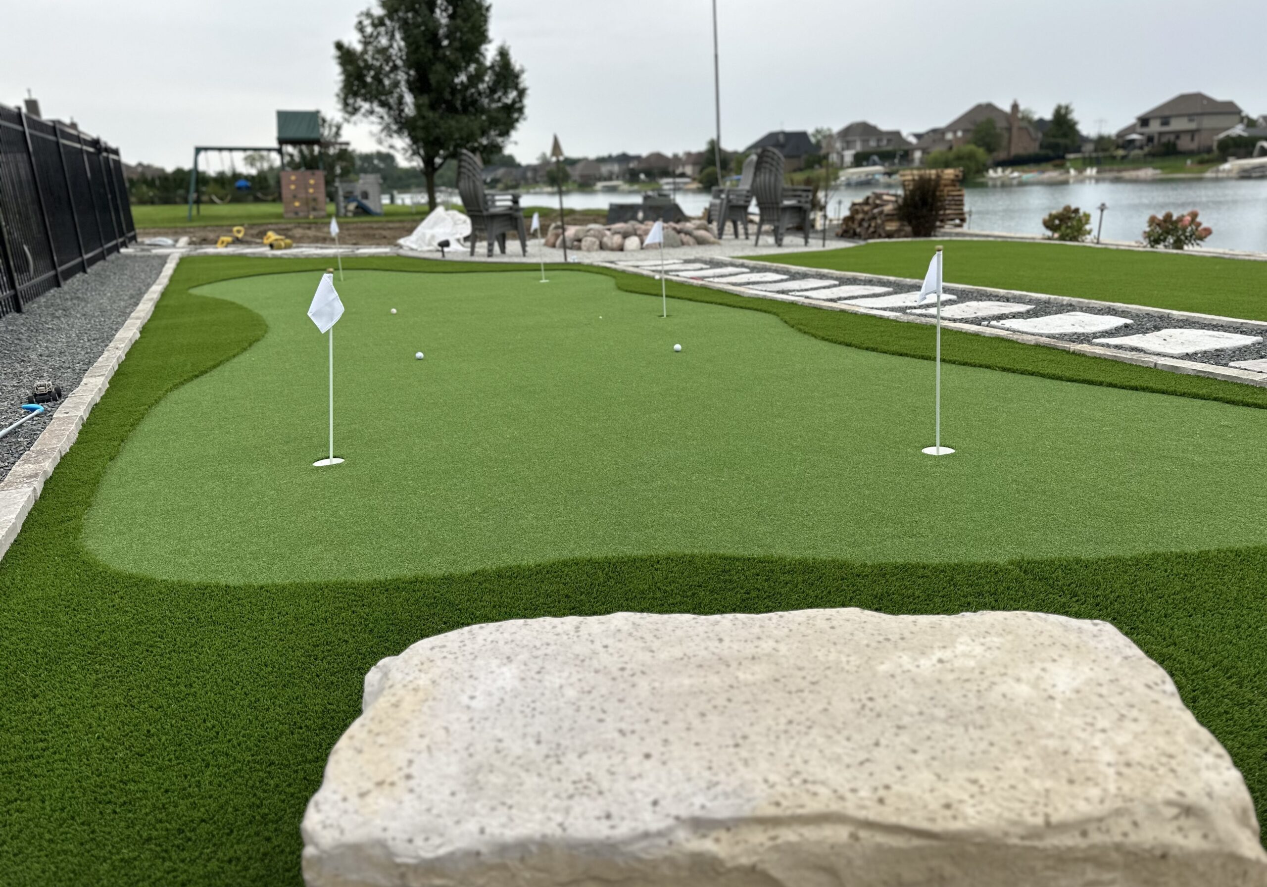 Backyard putting green beside lakeside patio