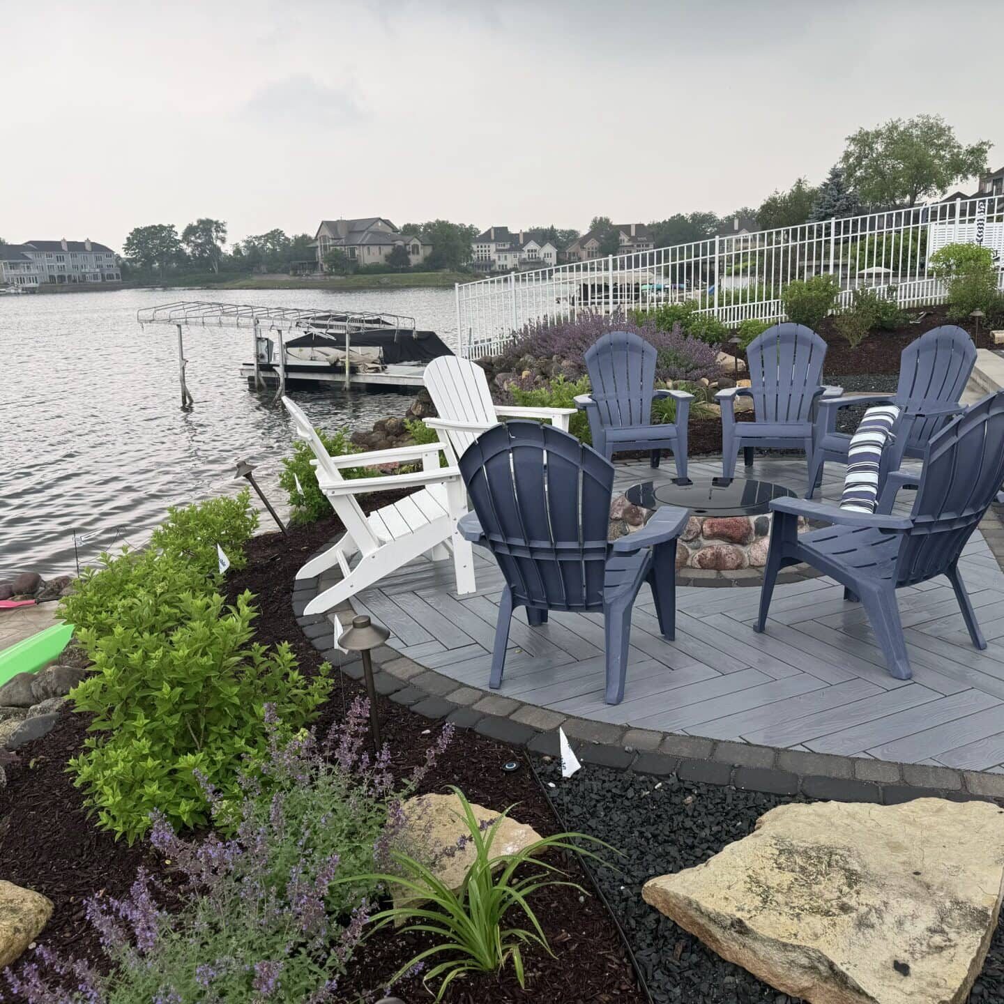 Lakeside patio with Adirondack chairs and plants