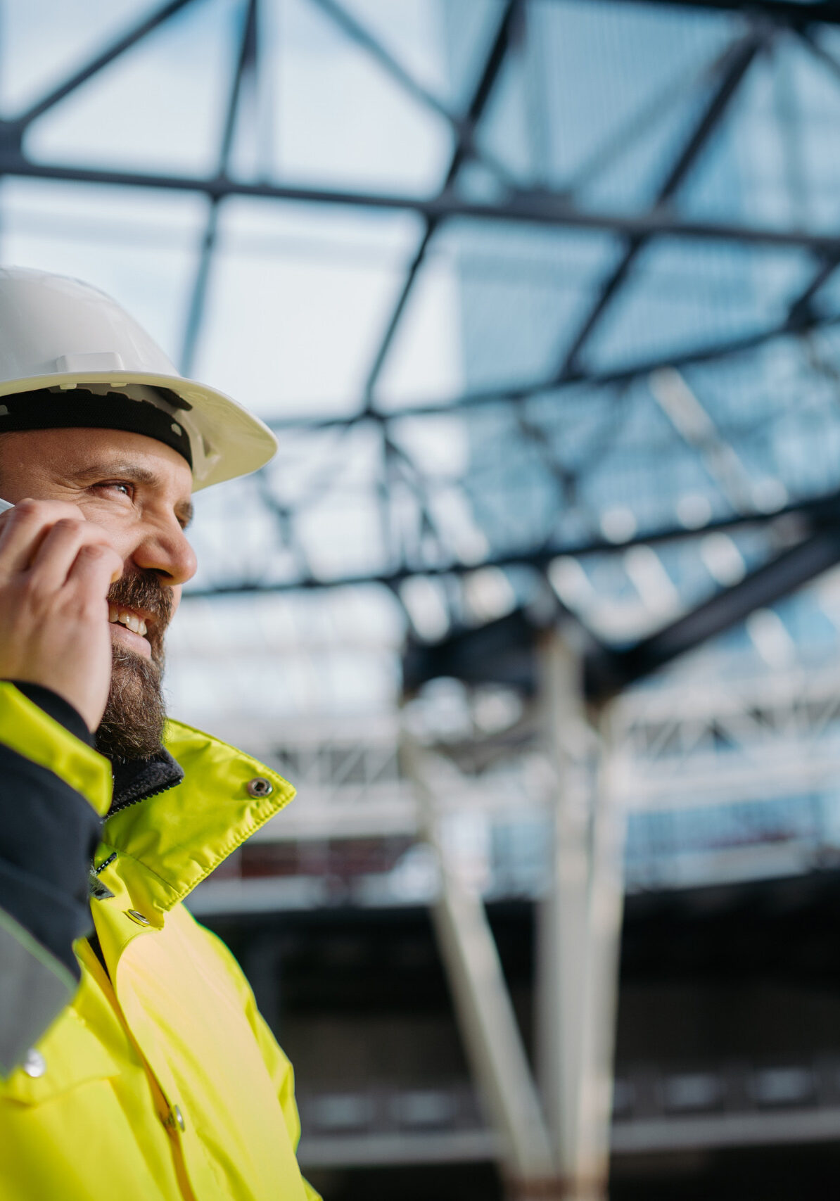 Construction worker in hard hat talking on phone